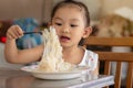 AsianÃ¢â¬â¹ childÃ¢â¬â¹ girlÃ¢â¬â¹ enjoyÃ¢â¬â¹ eatingÃ¢â¬â¹ someÃ¢â¬â¹ noodles